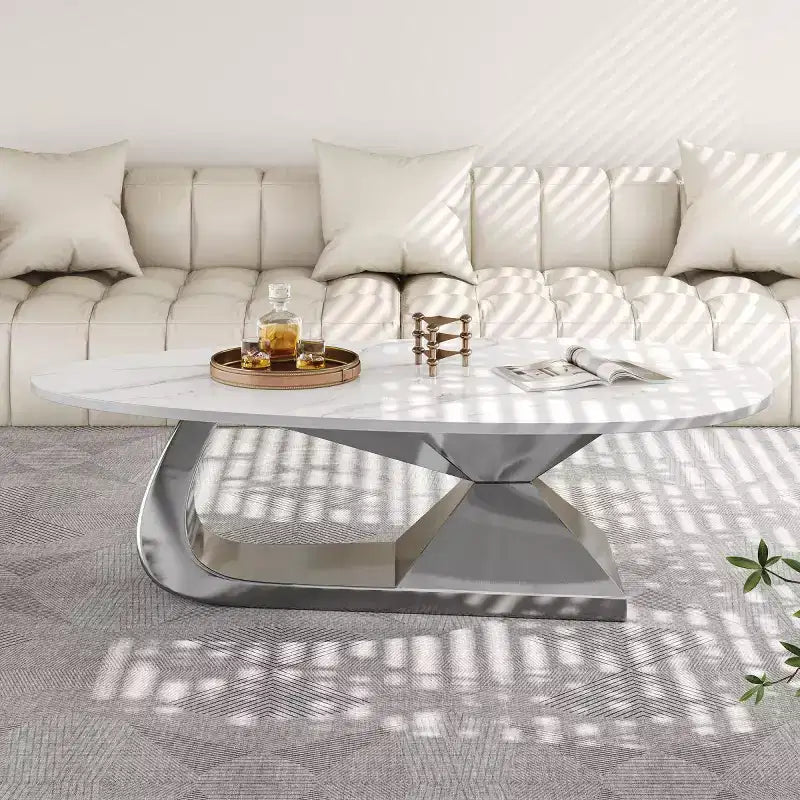Table basse moderne en pierre frittée avec base sculpturale en acier inoxydable, en forme de galet imitation marbre