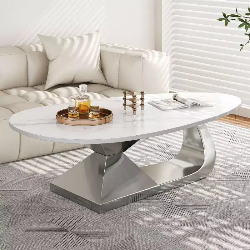 Table basse moderne en pierre frittée avec base sculpturale en acier inoxydable, en forme de galet imitation marbre